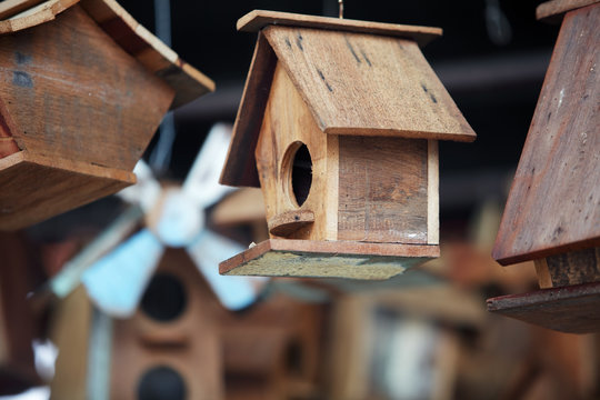 close up of hanging small wooden bird house