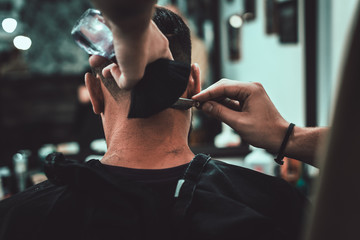 Barber leads the outline of a haircut. Men's haircut in barbershop