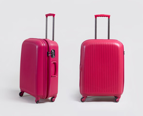 Pink small luggage bag side and front view isolated on white