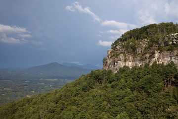 Fototapeta premium PILOT MOUNTAIN, NORTH CAROLINA - Pilot Mountain with storm gathering in the background.