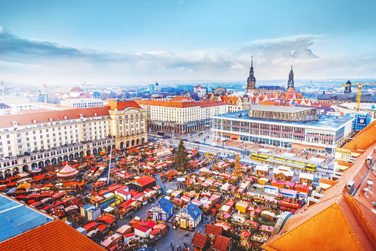 Dresden, Germany, Europe. Captivating view from above on Dresden central Christmas Market in Germany, Europe. Day scene. Classic red roofs, trading stalls, entertainment activities, ferry wheel etc.