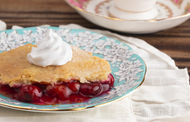 Slice of Homemade Cherry Cobbler on a Blue Antique Saucer