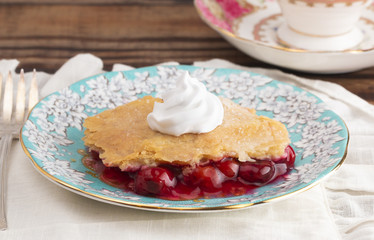 Slice of Homemade Cherry Cobbler on a Blue Antique Saucer