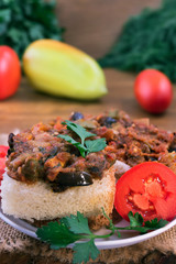 Sandwich of bread and vegetable stew with parsley and a slice of tomato.