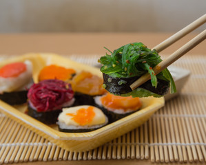 Sushi rolls served on a wooden plate
