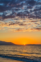 Naklejka premium Early morning , dramatic sunrise over sea and mountain. Photographed in Asprovalta, Greece.