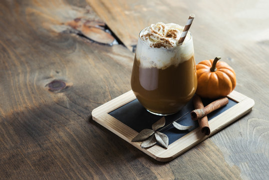 Pumpkin latte with spices, coffee autumn of fall drink with pumpkins, Thanksgiving table, copy space, selective focus