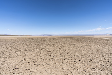 Dry Mojave desert lake with crusty mud patterns near Baker, California 