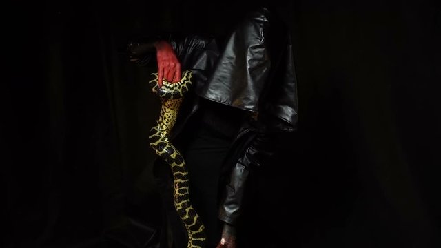 Anaconda and woman in black hood