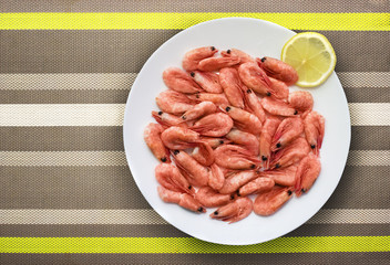 Appetizing red cooked sea shrimp with lemon slice on the plate, seafood, shellfish.