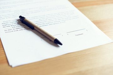closeup of signing a documentation agreement and pen on the table.