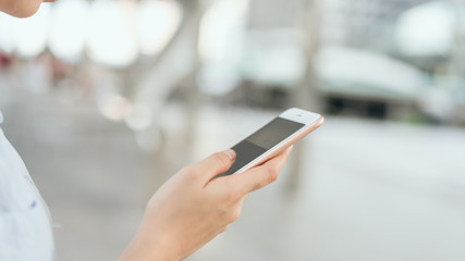 woman using smartphone on staircase in public areas, During leisure time. The concept of using the phone is essential in everyday life.