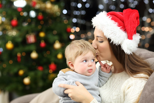 Mother kissing her baby son in christmas