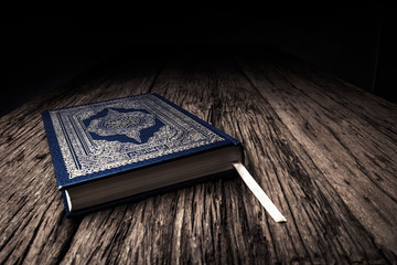 Koran - holy book of Muslims ( public item of all muslims ) on the table , still life