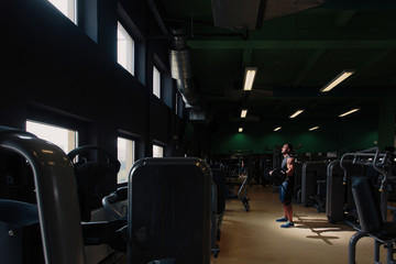 Naklejka na ściany i meble Man doing training alone in the gym