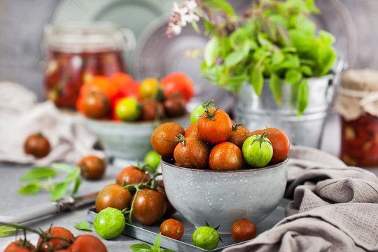 Fresh ripe cherry tomatoes in bowl on gray background