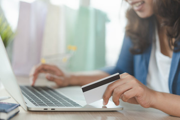 close up shots hands of person shopping on ecommerce and using credit card payment via online...
