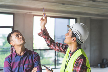 Client and Contractor discussing plan to renovation house.