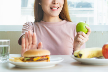 Woman on dieting for good health concept. Woman doing cross arms sign to refuse junk food or fast...