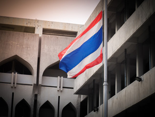 Thailand flag blows in the wind in morning light.