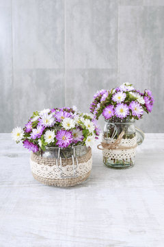 Bouquet of purple and white chrysanthemum flowers in glass jar