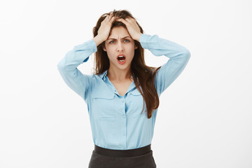 Girl going crazy from stupid coworker. Portrait of fed up displeased funny woman, holding hands on...