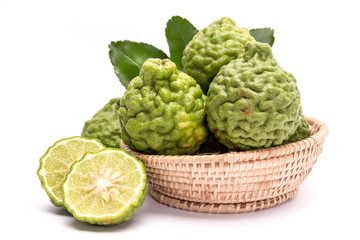 The kaffir lime leaves in the basket on a white background.