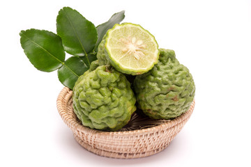 Fototapeta premium The kaffir lime leaves in the basket on a white background.