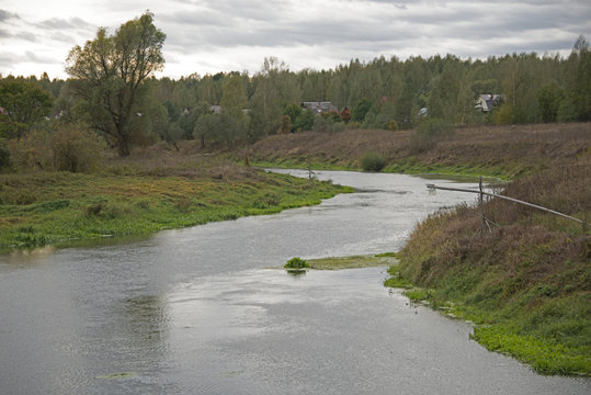 Russian rural landscape - small village on the river bank