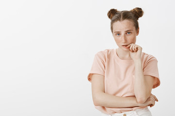 Portrait of tired and smart good-looking fashionable girlfriend with cute buns hairstyle and...