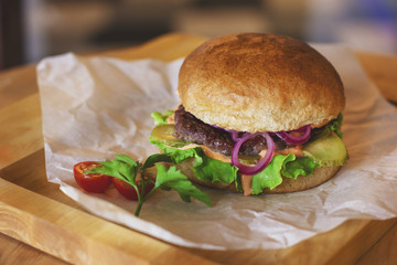 Fresh meat Burger with pickled onions on wooden Board