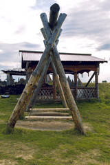 Swings made of logs with chains in the clearing