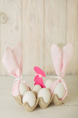 Happy easter. Decor of Easter eggs - napkins in the form of ears of Easter rabbits.