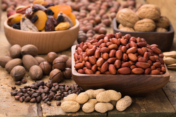 peanut indian peeled in wooden bowl on table, grunge style.