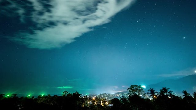 Clouds, stars and thunderstorm in the sky over island. 4k time lapse
