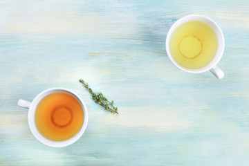 An overhead photo of tea, on a teal background with copy space
