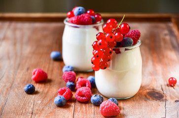 Healthy  yogurt with berry and mint on the wooden table, selective focus