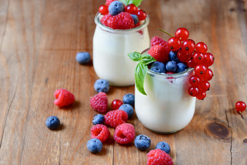 Healthy  yogurt with berry and mint on the wooden table, selective focus