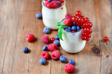 Healthy  yogurt with berry and mint on the wooden table, selective focus