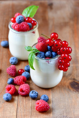Healthy  yogurt with berry and mint on the wooden table, selective focus