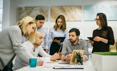 Group of young creative people work in office.