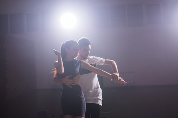 Active happy adults dancing bachata together in dance class
