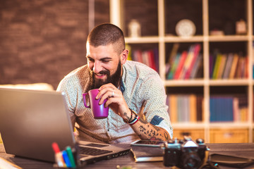 Young man working on his laptop computer at home