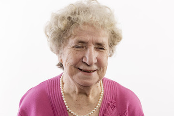 Old woman smiles, close-up, isolated on white background