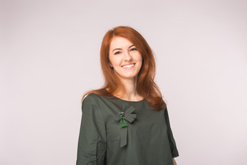 Fashion and people concept - Portrait of happy ginger woman smiling looking at camera over white background