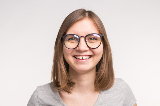 Portrait of white young woman with short brown hair in a glasses.