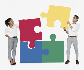 Businesspeople connecting jigsaw puzzle pieces