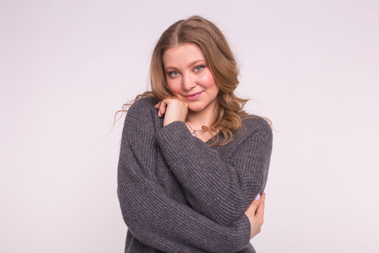 Young Blonde Woman Wearing Grey Wool Sweater On White Background