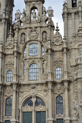 Fototapeta premium Cathedral, Santiago de Compostela, Spain. Baroque facade closeup with windows and clouds reflections.