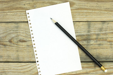 White cardboard and pencil on wooden desk 